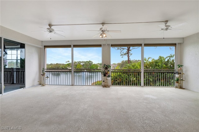 unfurnished sunroom with a water view