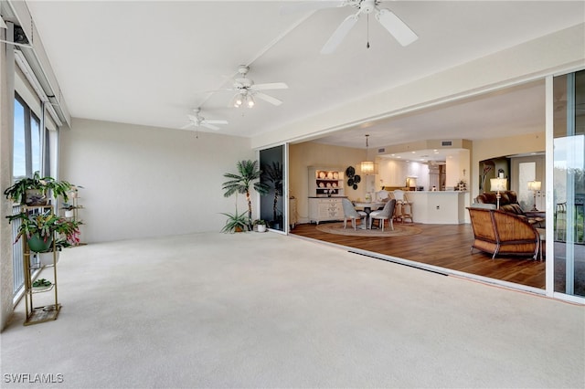 living room with wood-type flooring and ceiling fan