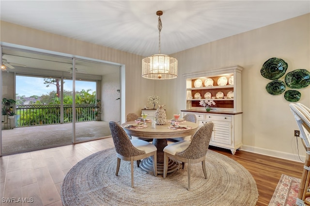 dining area featuring ceiling fan, built in features, and hardwood / wood-style floors