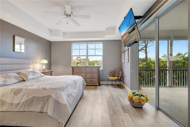 bedroom with ceiling fan, light hardwood / wood-style floors, and access to exterior