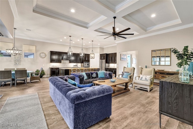 living room featuring light hardwood / wood-style floors, ornamental molding, and coffered ceiling