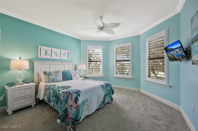 carpeted bedroom featuring ceiling fan, baseboards, and crown molding