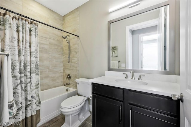 full bath with toilet, shower / bath combo with shower curtain, wood finished floors, and vanity