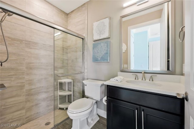 full bath featuring a shower stall, toilet, and vanity