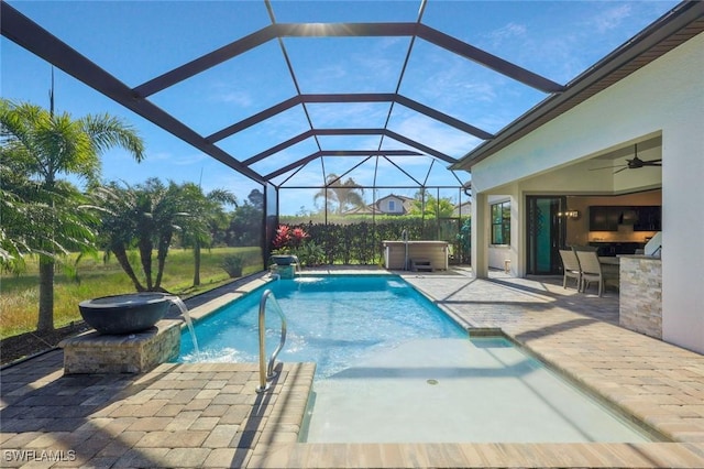 pool with a ceiling fan, a lanai, a patio, and a hot tub