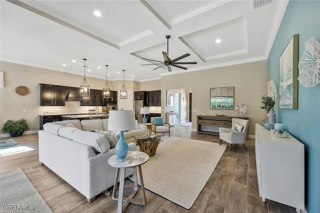 living room with baseboards, coffered ceiling, wood finished floors, beamed ceiling, and crown molding