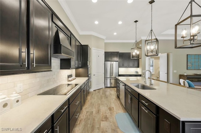 kitchen featuring stainless steel appliances, a sink, light countertops, light wood finished floors, and custom range hood