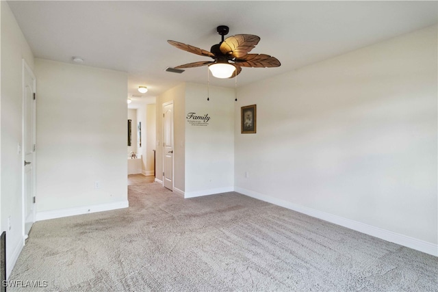 unfurnished room featuring ceiling fan and light colored carpet