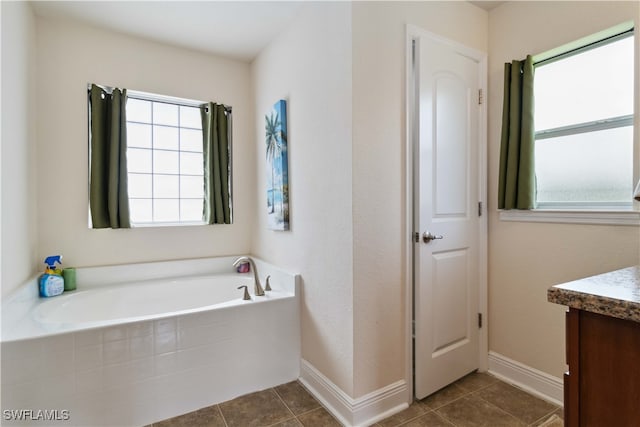 bathroom with vanity, tiled tub, and tile patterned floors