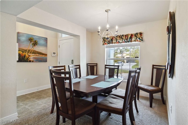 tiled dining area featuring an inviting chandelier