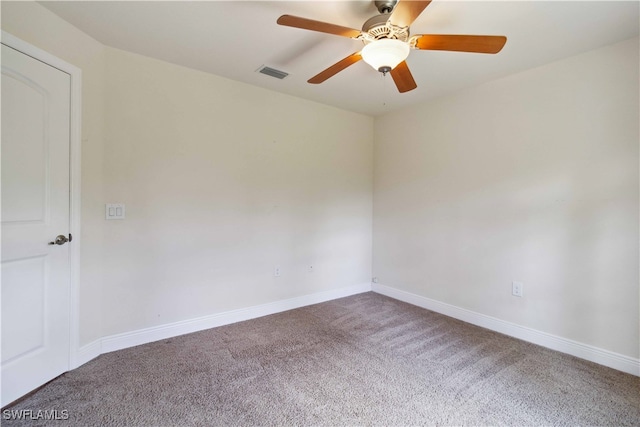 carpeted spare room featuring ceiling fan