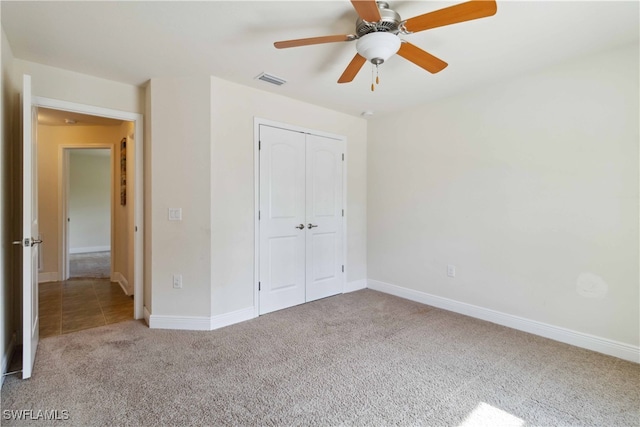 unfurnished bedroom featuring a closet, ceiling fan, and light colored carpet