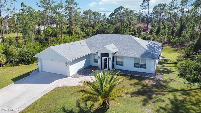 view of front of home with a garage and a front lawn