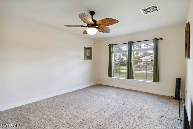 carpeted spare room featuring ceiling fan