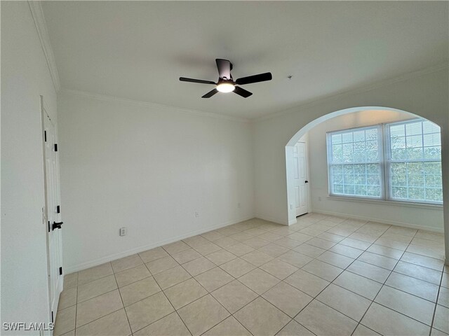 tiled spare room with crown molding and ceiling fan