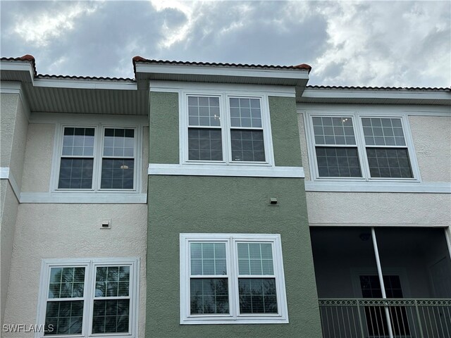 view of side of home with a balcony