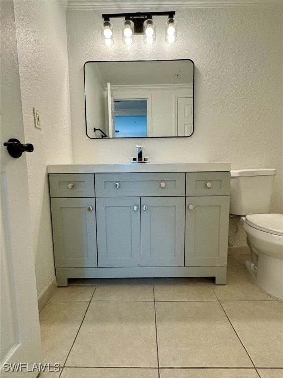 bathroom with vanity, toilet, and tile patterned flooring