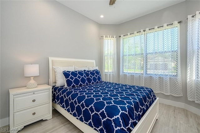 bedroom with light hardwood / wood-style flooring and ceiling fan