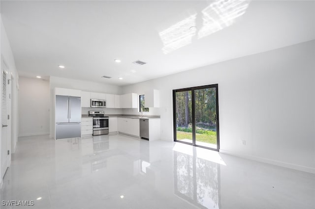 kitchen with visible vents, recessed lighting, stainless steel appliances, white cabinets, and modern cabinets