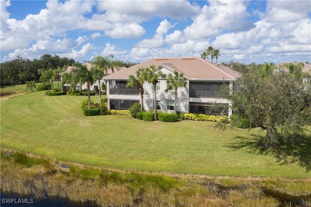 view of front of property with a front lawn and a sunroom