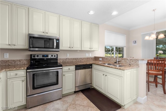 kitchen with sink, kitchen peninsula, light stone counters, appliances with stainless steel finishes, and pendant lighting