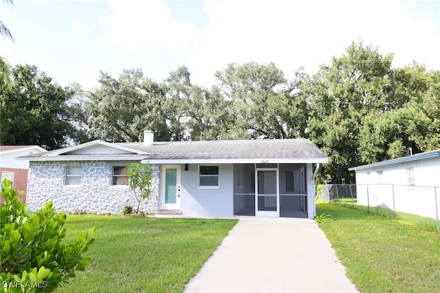 view of front of house featuring a front yard and a sunroom