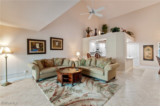 tiled living room featuring high vaulted ceiling and ceiling fan