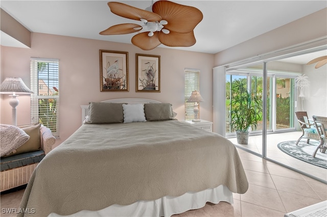 tiled bedroom with ceiling fan and access to exterior