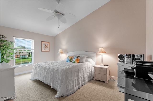 bedroom featuring ceiling fan, light colored carpet, and vaulted ceiling