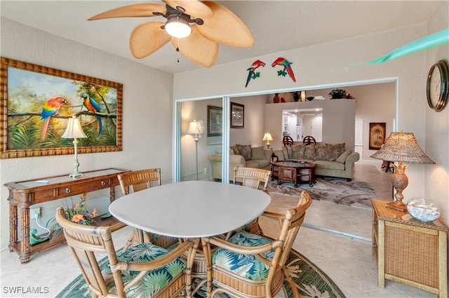 dining area featuring ceiling fan and light tile patterned floors