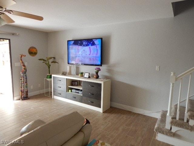 living room featuring hardwood / wood-style flooring and ceiling fan