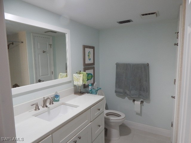 bathroom featuring vanity, toilet, and tile patterned flooring