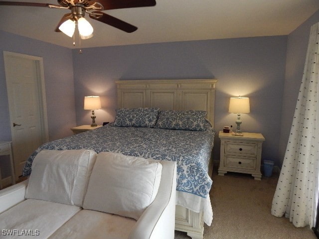 bedroom featuring a closet, light colored carpet, and ceiling fan