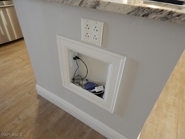 details featuring stainless steel dishwasher and hardwood / wood-style floors