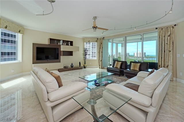 living room with ornamental molding, a healthy amount of sunlight, and ceiling fan