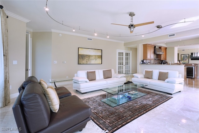 living room with crown molding, track lighting, ceiling fan, and beverage cooler