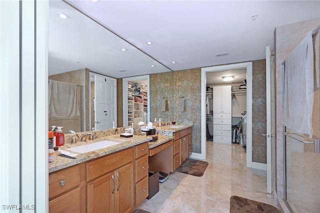 bathroom featuring vanity, tile walls, and a shower with shower door