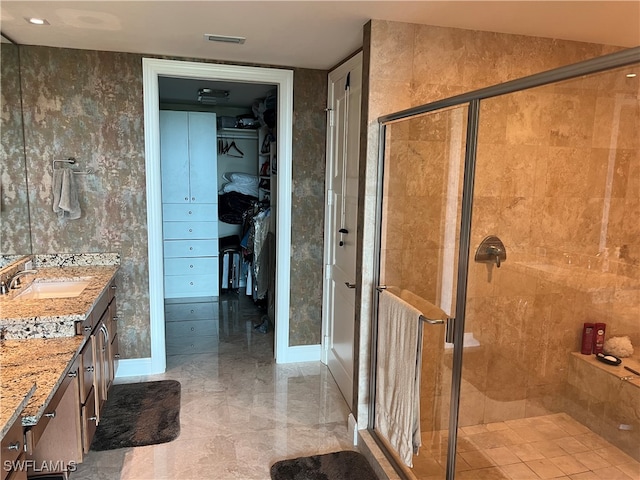 bathroom featuring vanity, vaulted ceiling, and a shower with door