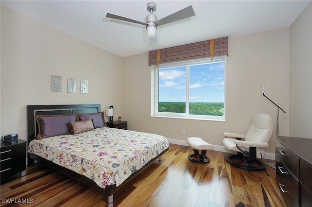 bedroom with wood-type flooring and ceiling fan