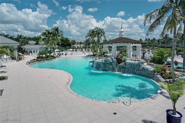 view of swimming pool with a patio, a gazebo, and pool water feature