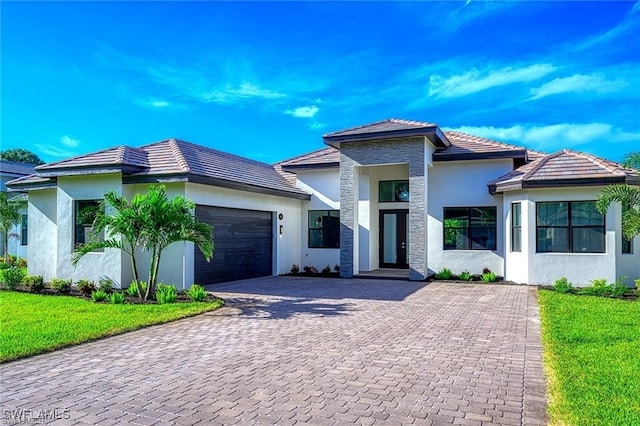 view of front of property featuring a garage and a front lawn