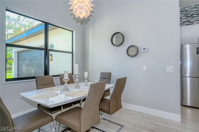 dining space with light hardwood / wood-style flooring