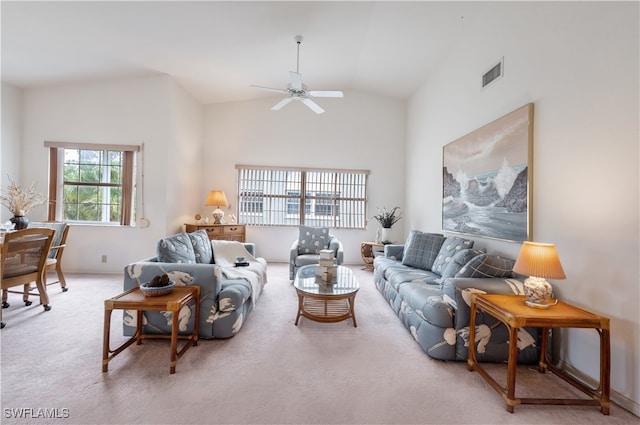 carpeted living room with high vaulted ceiling and ceiling fan