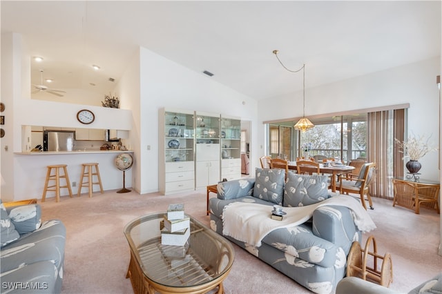 living room featuring ceiling fan, carpet flooring, and high vaulted ceiling