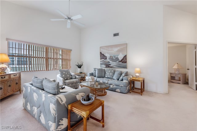 carpeted living room with high vaulted ceiling and ceiling fan