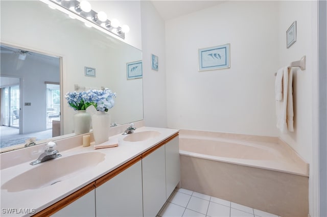 bathroom featuring a bathtub, vanity, and tile patterned flooring