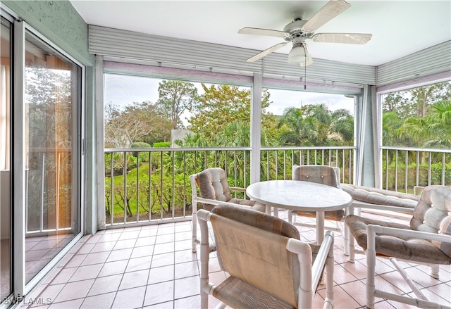 sunroom featuring ceiling fan and plenty of natural light