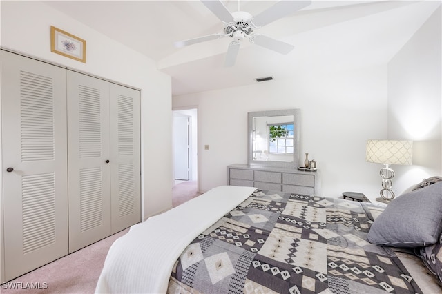 bedroom featuring light colored carpet, ceiling fan, and a closet