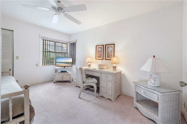 carpeted office space featuring ceiling fan