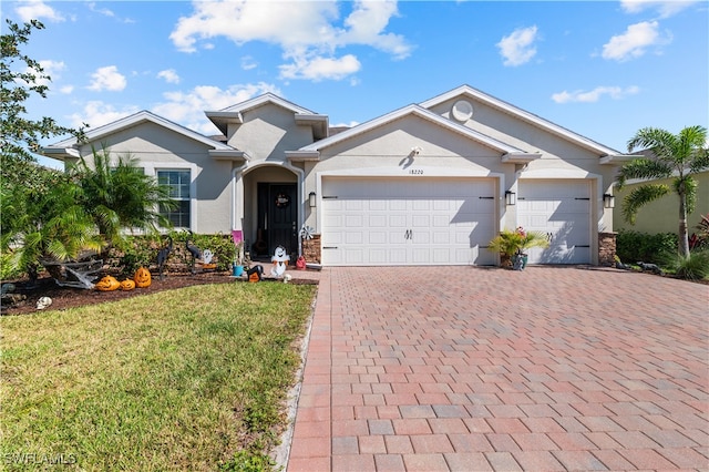 view of front of property with a front yard and a garage